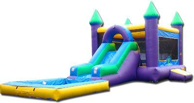 a purple and green bouncy house with a slide and a pool .