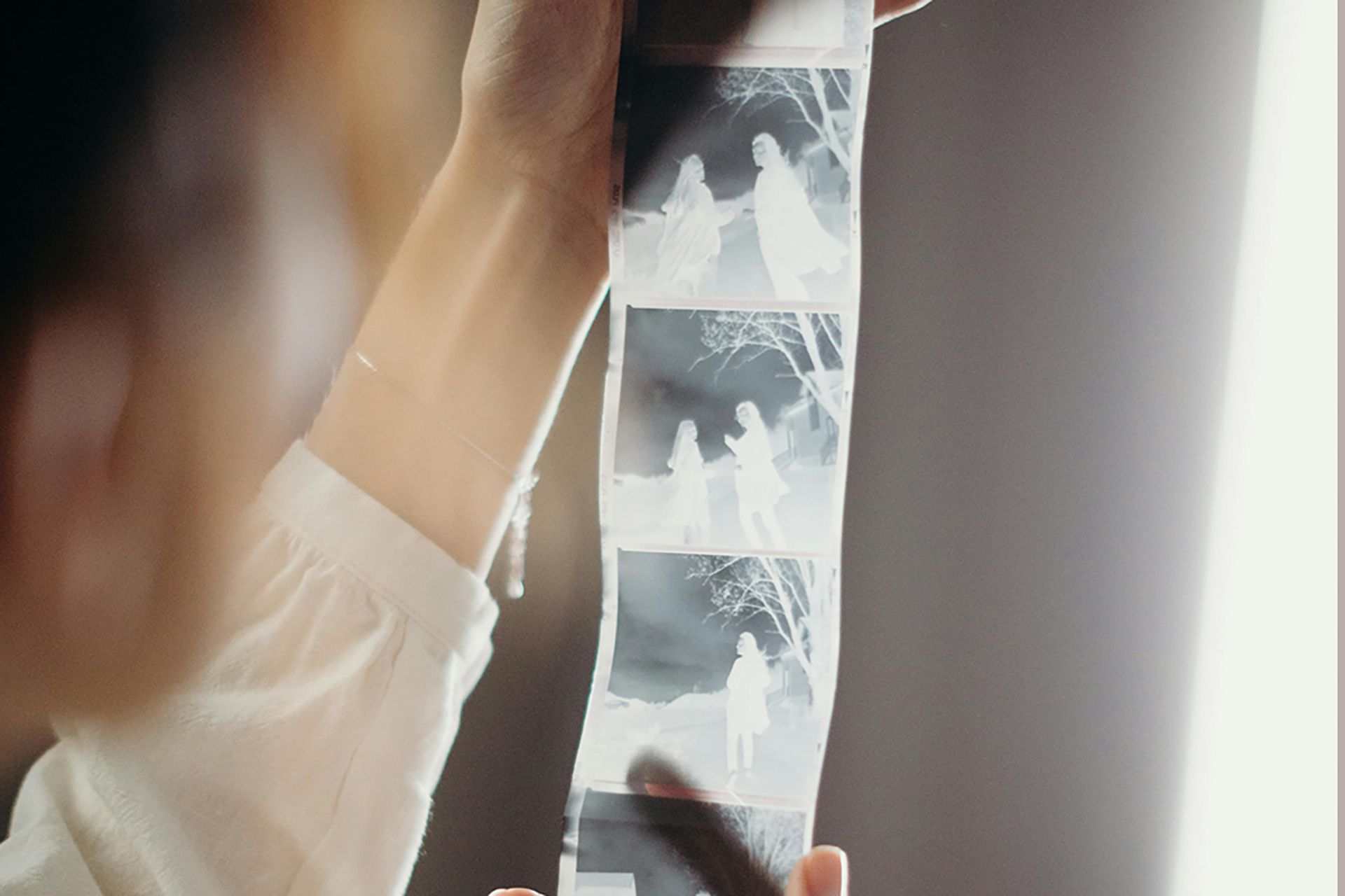 hands holding film strip
