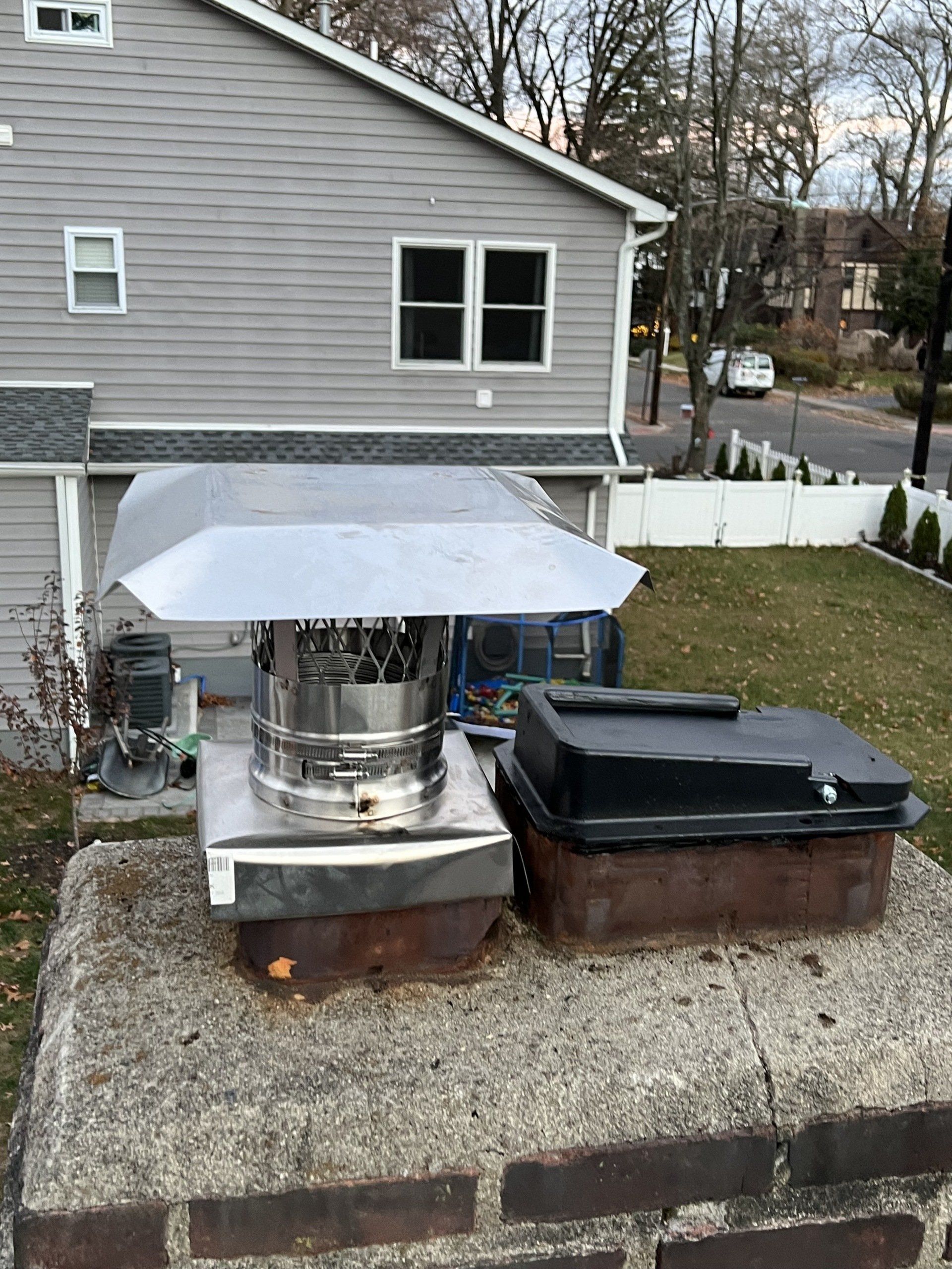 Chimney cap installed on chimney crown.