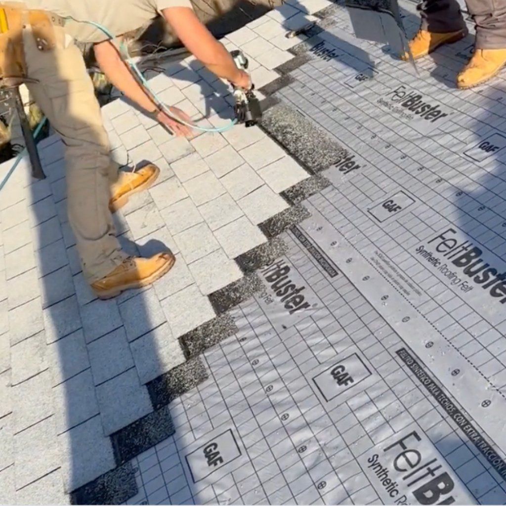 Contractor installing shingles on roof.