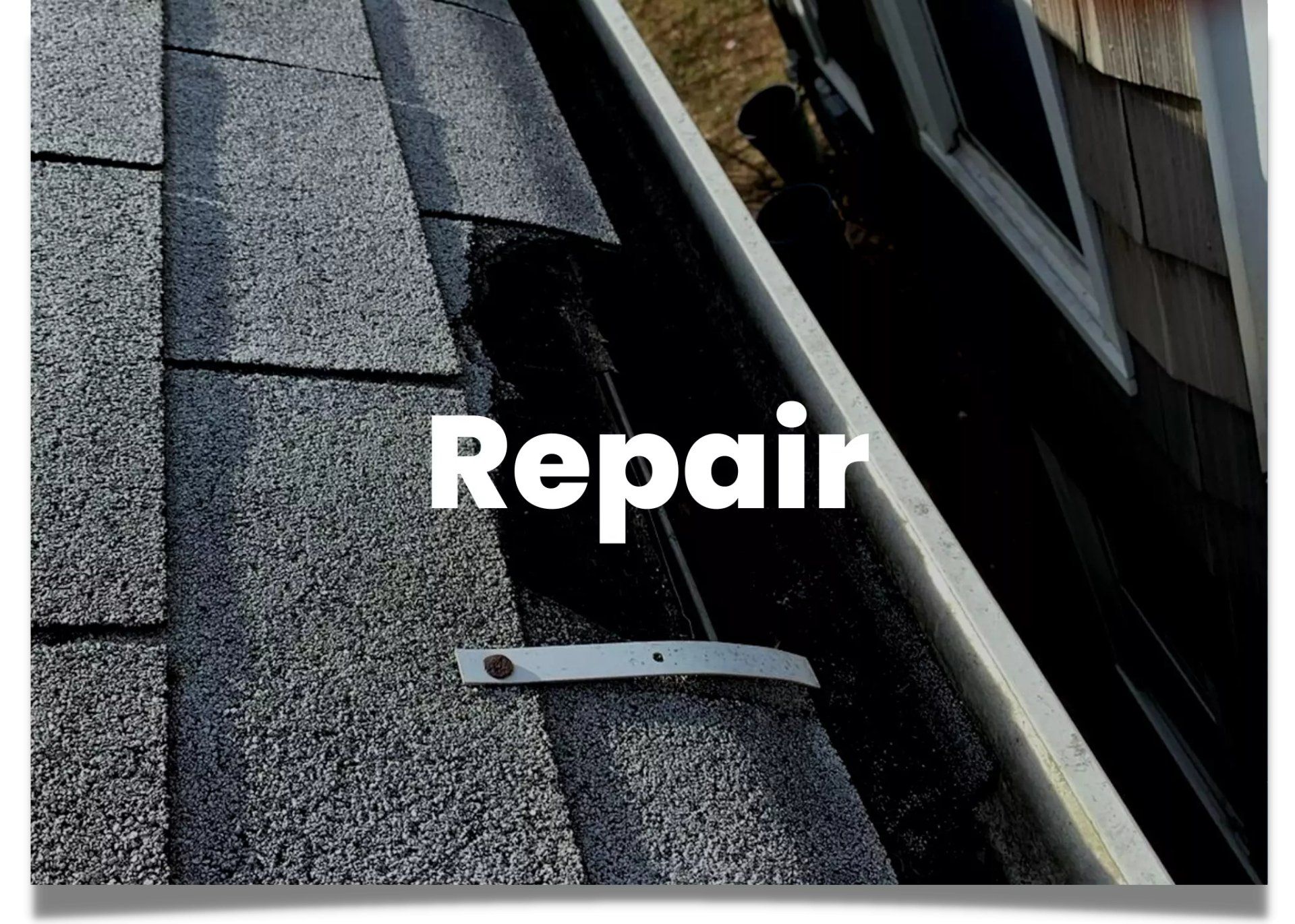 Broken asphalt shingle on a residential property.