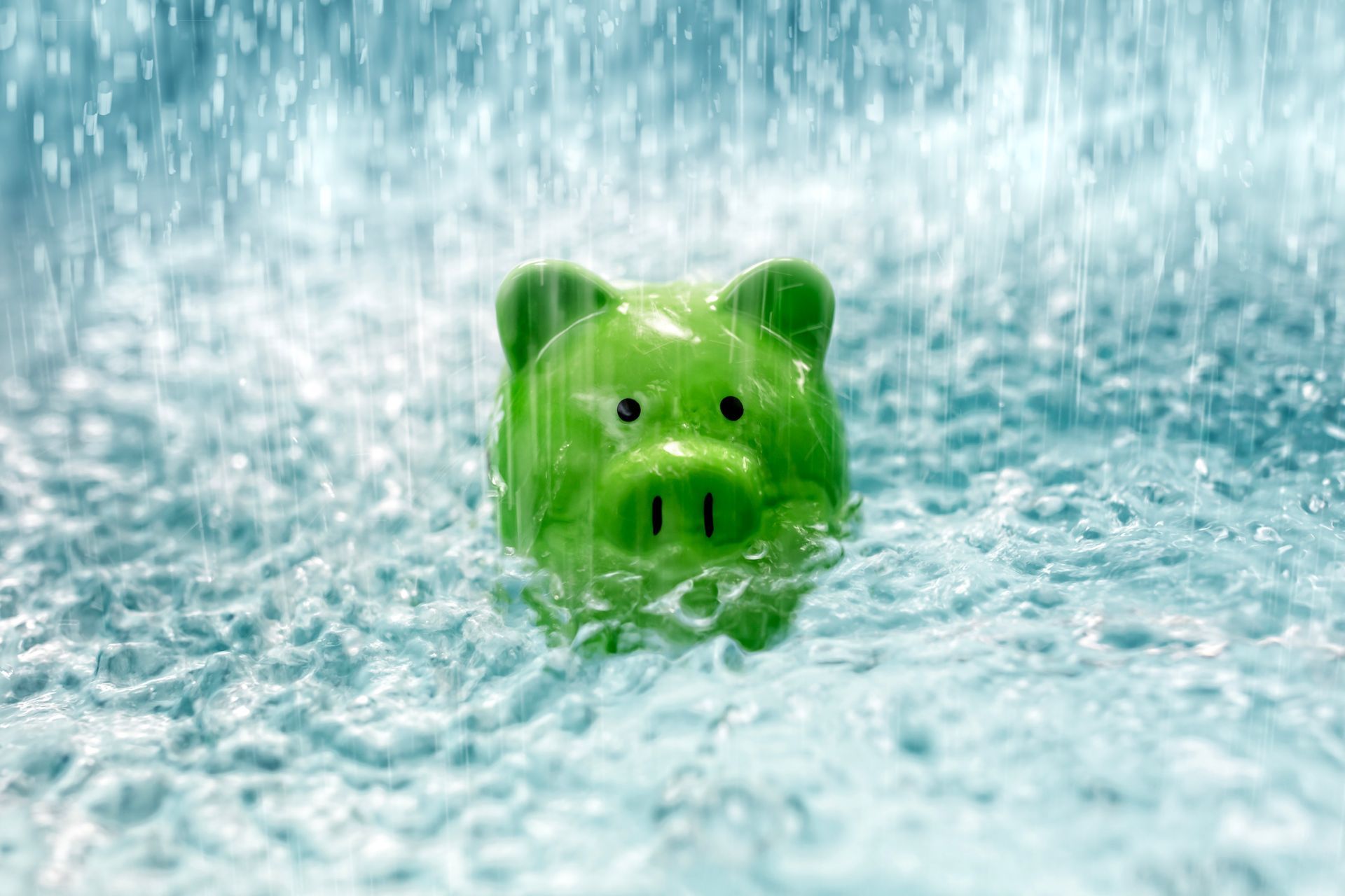 Green pig figurine peeking through foamy water or bubbles
