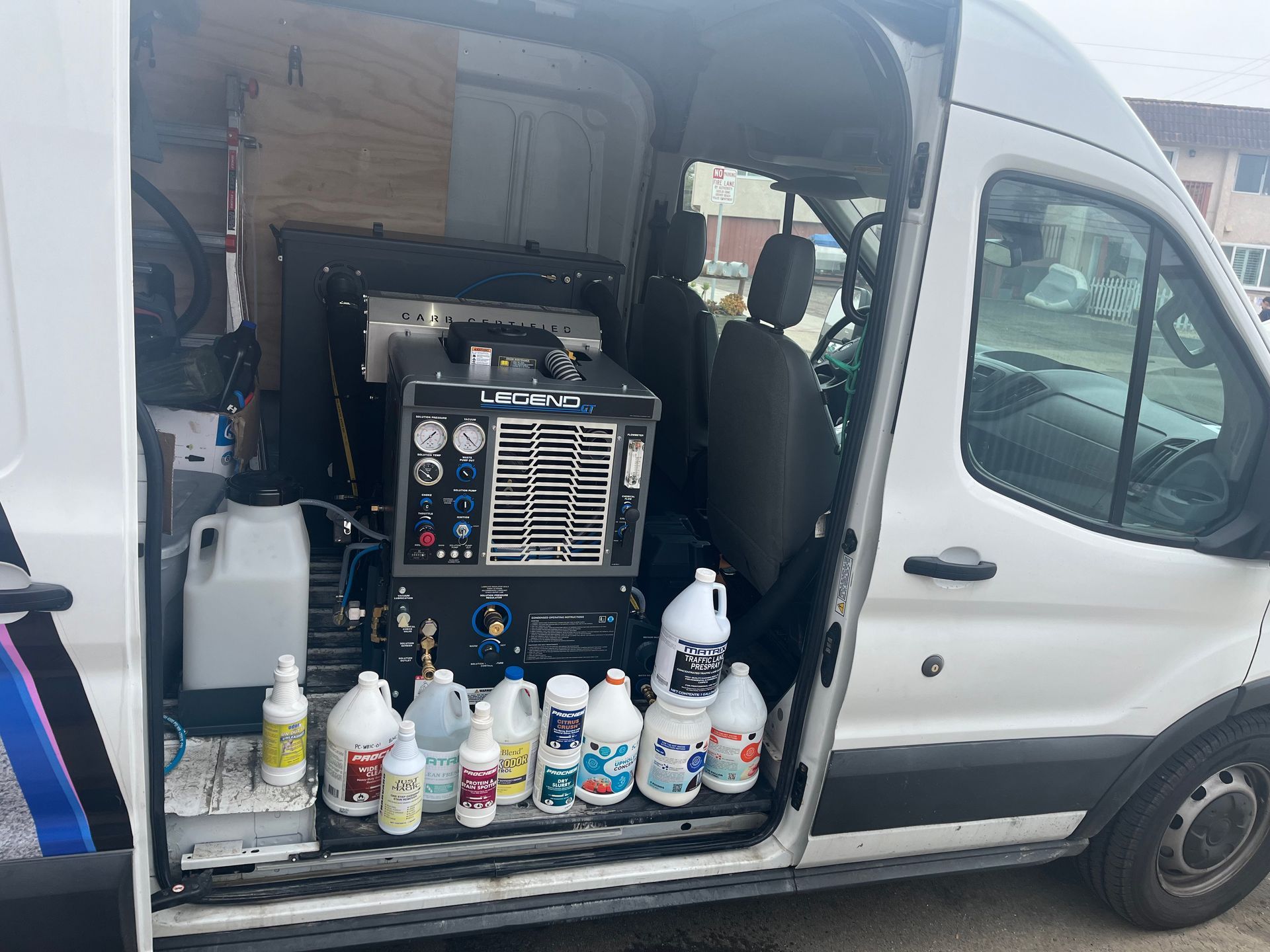 Home cleaning services A white van is filled with cleaning supplies and a machine.