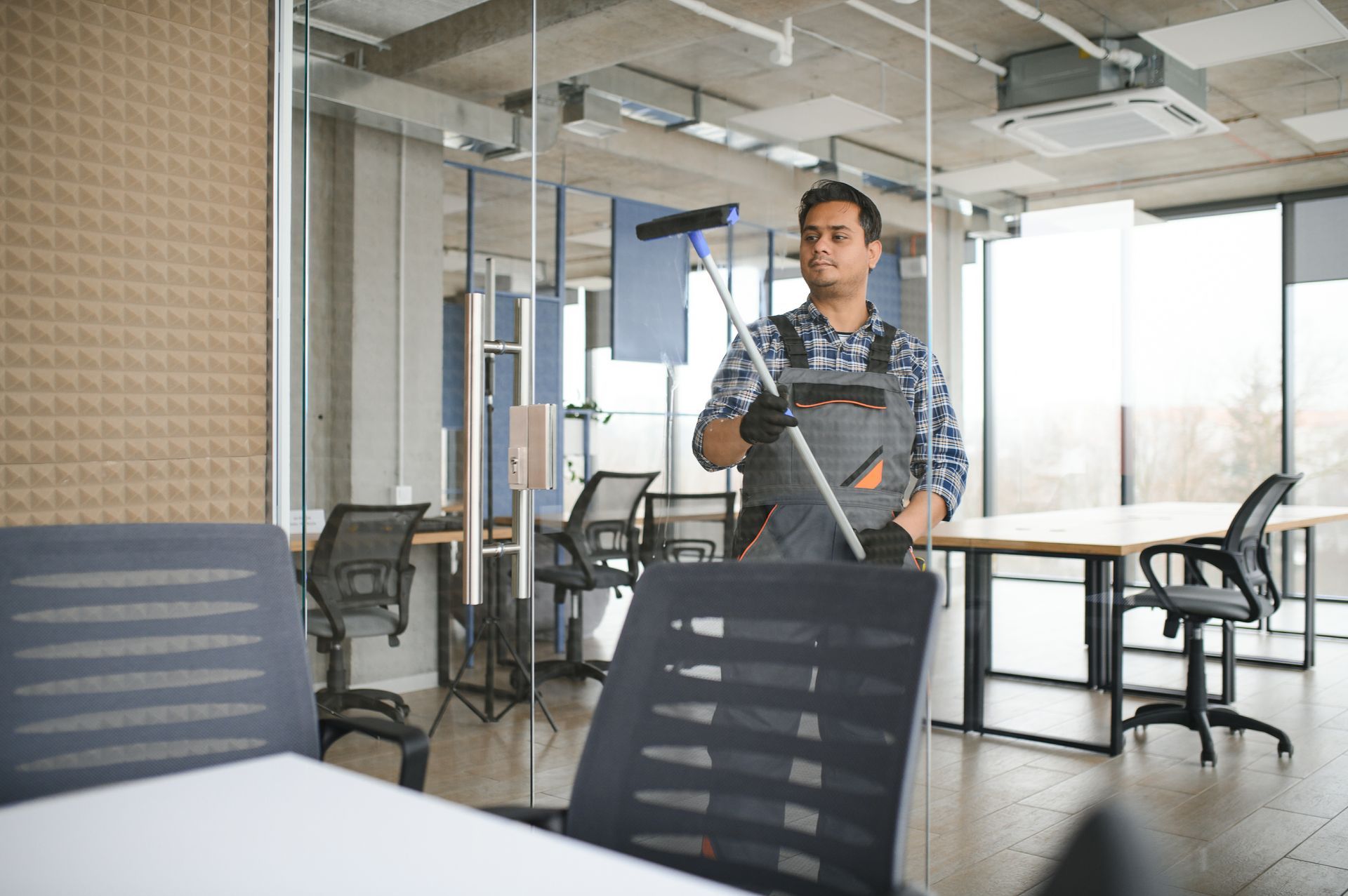 commercial cleaning services A man is cleaning an office with a vacuum cleaner.