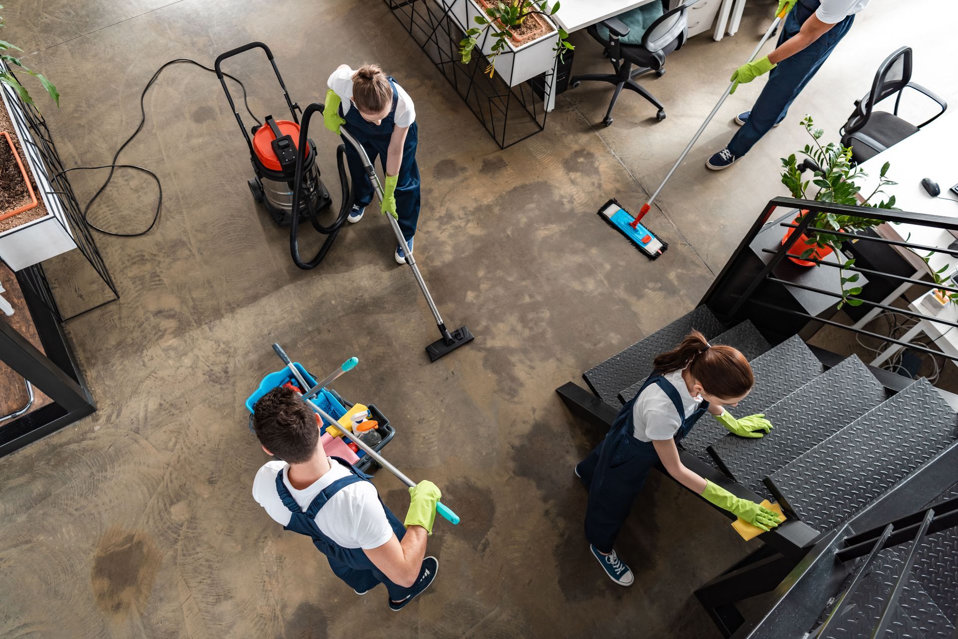 A group of people are cleaning company for offices with cleaning supplies.