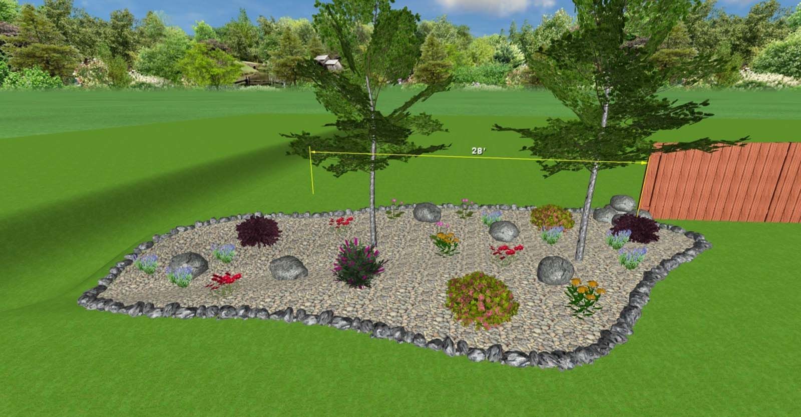 Raised flower bed with scattered colorful plants and small trees in a grassy yard