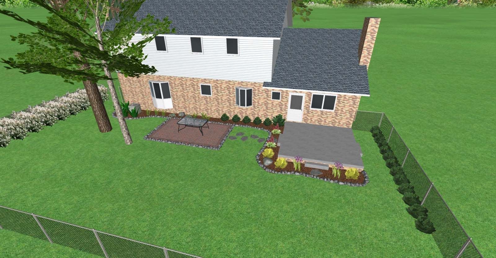 Aerial view of a beige two-story house with a small patio, flower beds, and a fenced green yard.