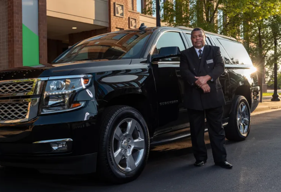 chauffeur awaiting passengers for JFK airport transfer