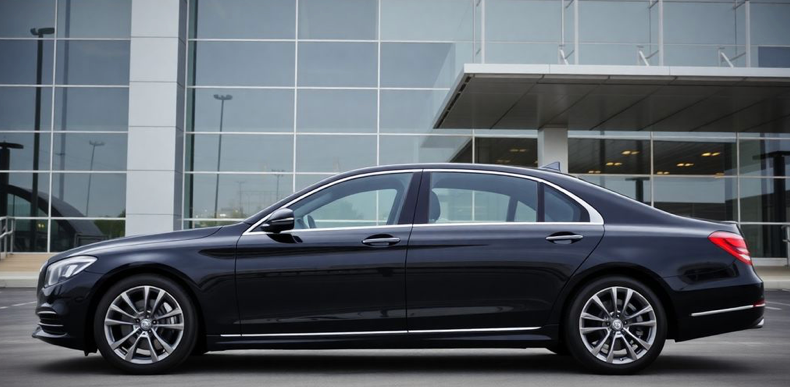 Luxury sedan arriving at an airport terminal