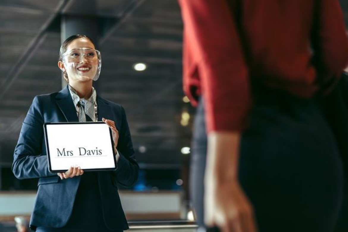 professional chauffeur holding sign