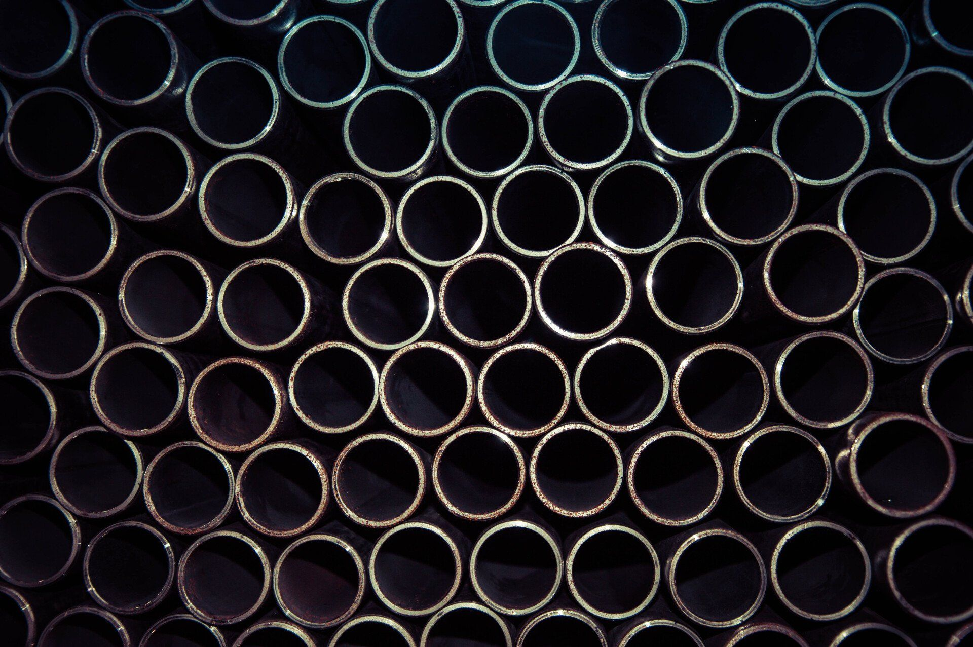 A bunch of metal pipes stacked on top of each other