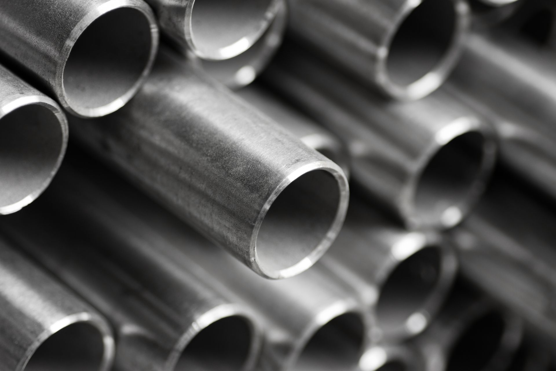 A bunch of metal pipes are stacked on top of each other.