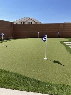 contractors installing artificial grass at a lawn