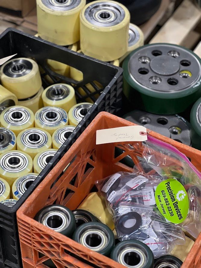 A crate filled with wheels and a bag of bearings