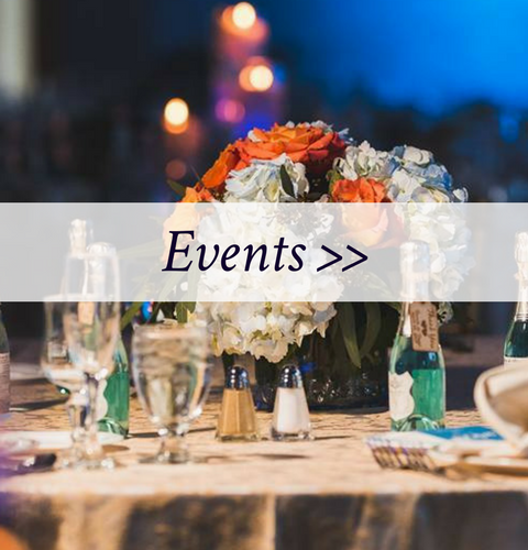 Elegant banquet table with floral centerpiece and “Events >>” banner overlay