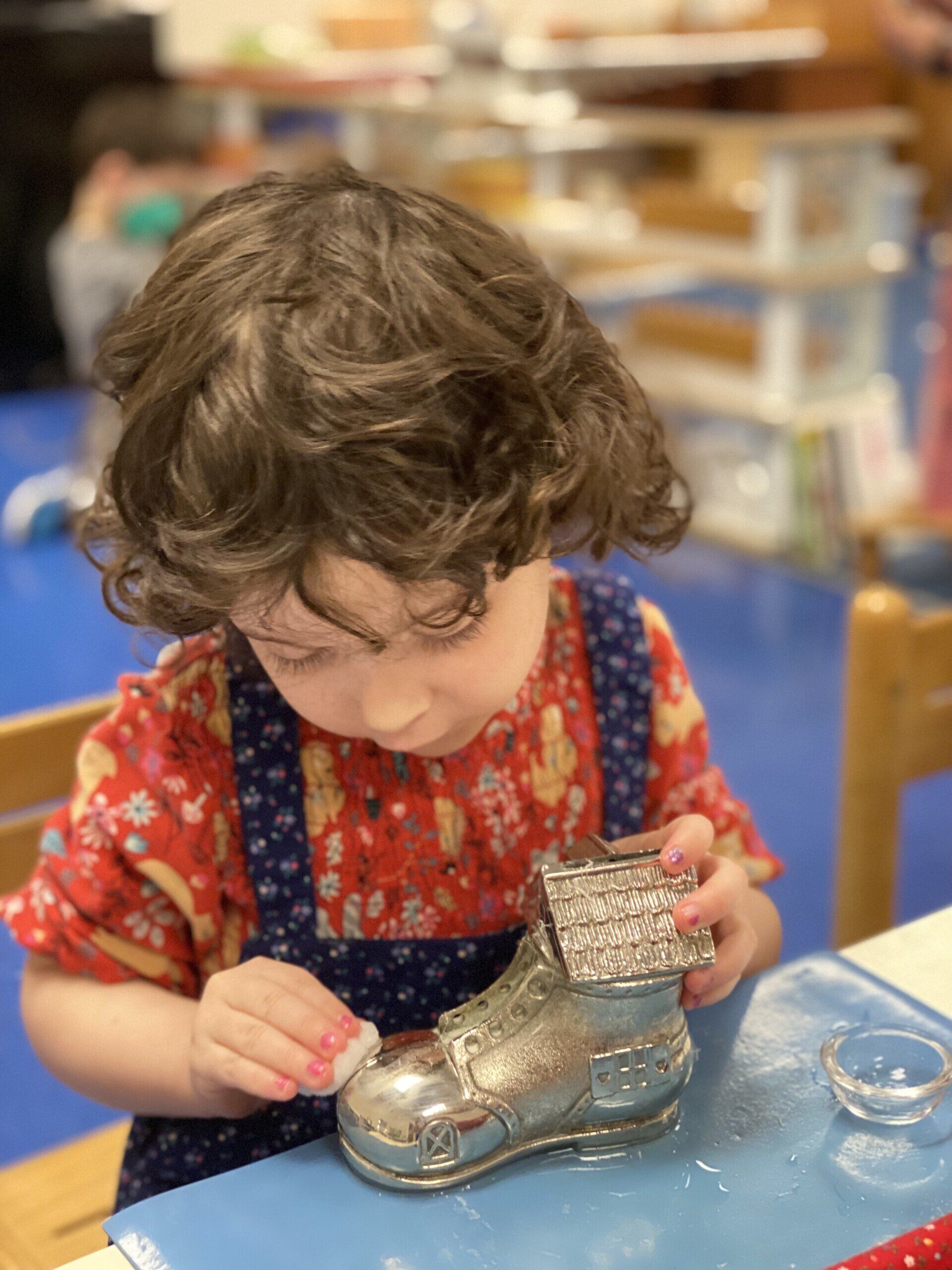Child working with Montessori practical life materials