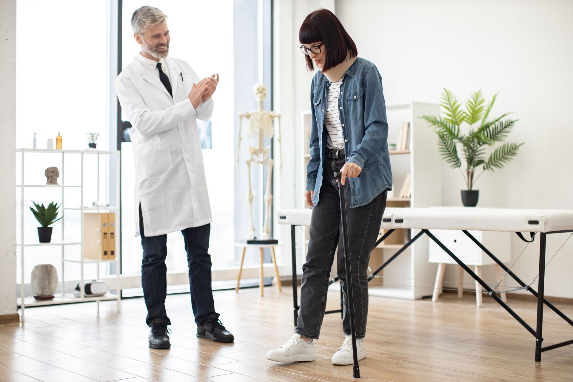 A woman with a cane is talking to a doctor in a hospital.