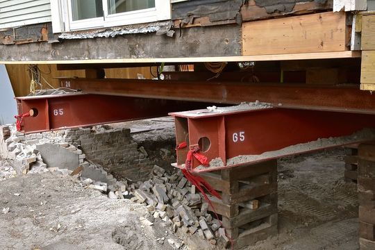 a couple of red boxes sitting on top of a pile of rubble