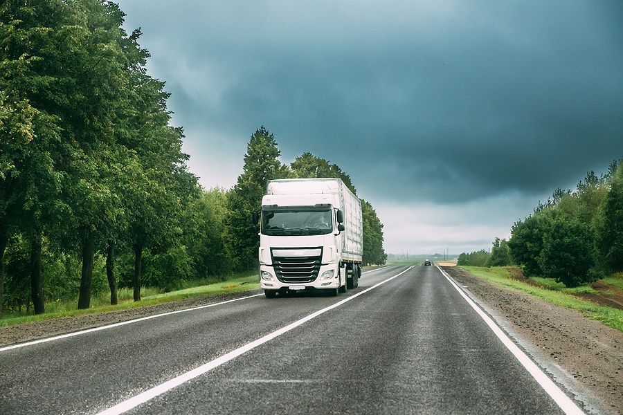 White semi-truck on road for long distance moving.