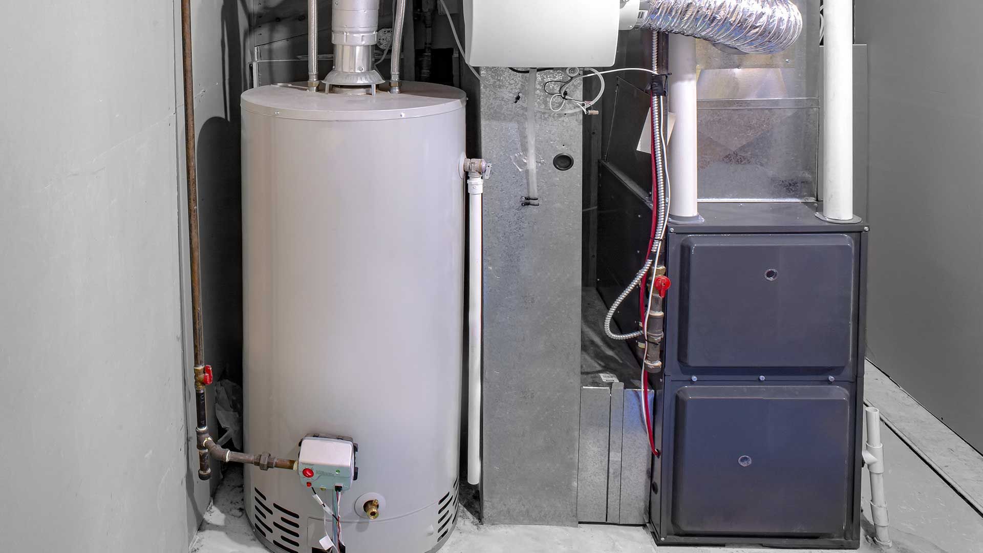 Mechanical room with furnace, ductwork, and stacked dark cabinets against a wall