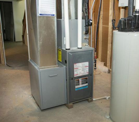 Furnace and ductwork in an unfinished basement utility room