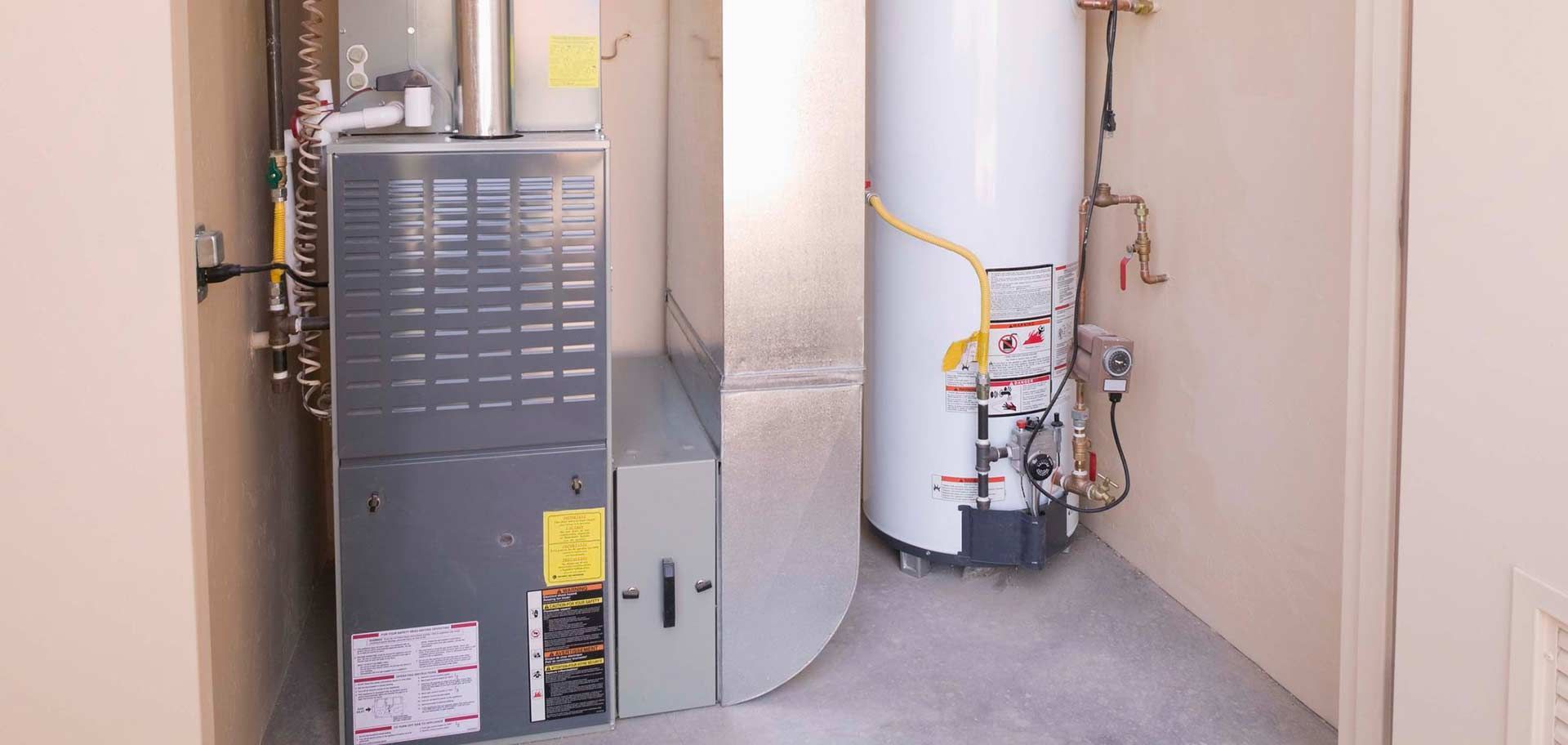 Utility closet with a furnace, water heater, and exposed pipes
