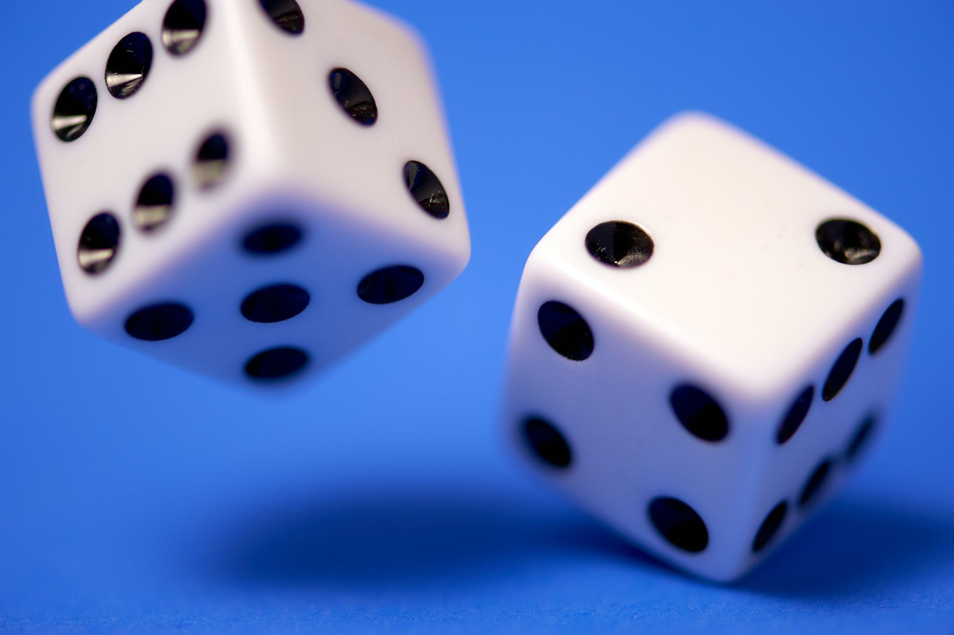 dice rolling on a blue background