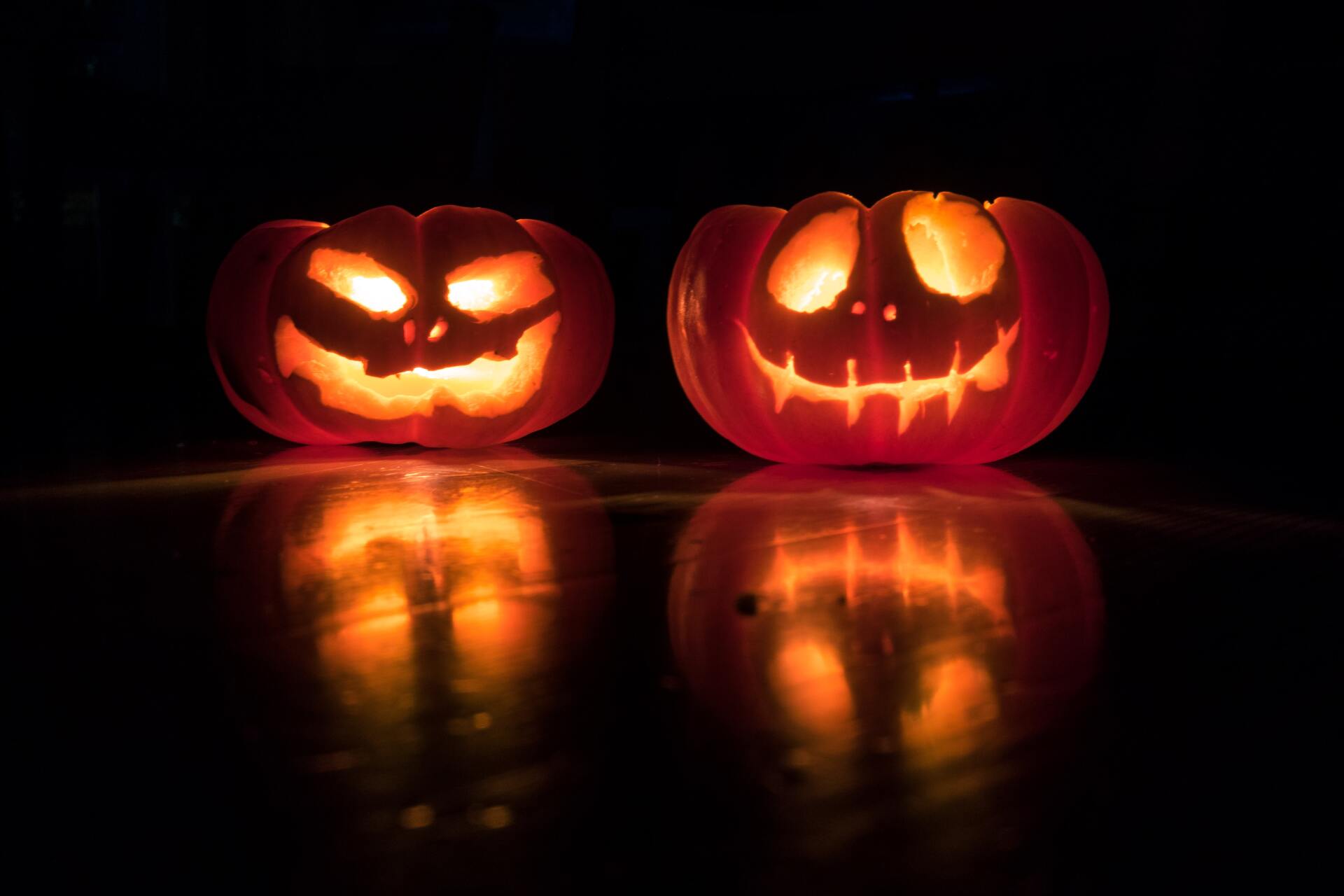 Halloween pumpkins lit up in the dark.