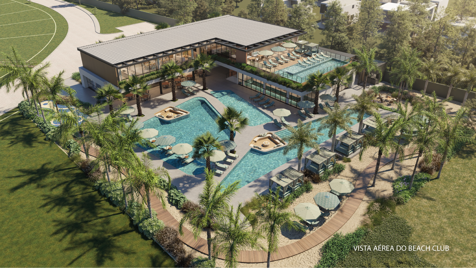 Vista aérea de um resort tropical com piscina central, palmeiras, espreguiçadeiras e um prédio moderno de baixa altura.