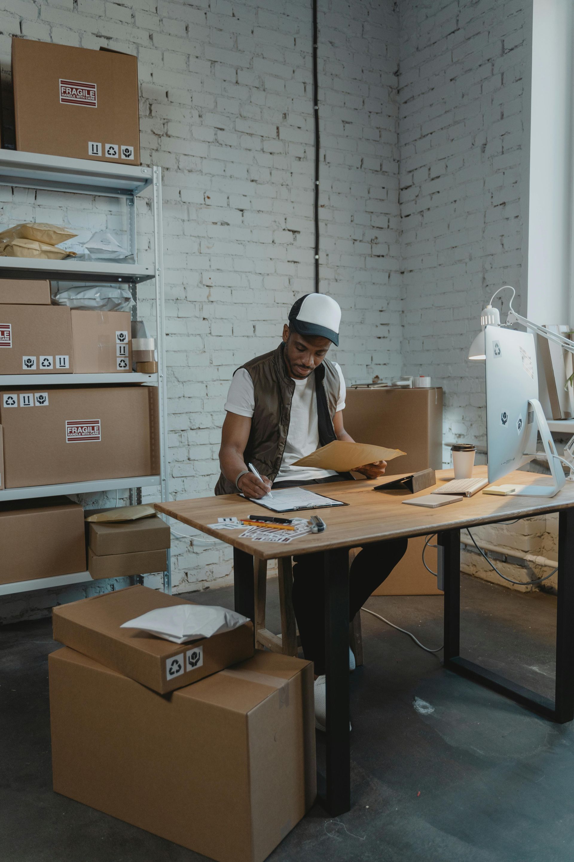 Inventory manager reviewing stock levels in Amazon fulfillment warehouse