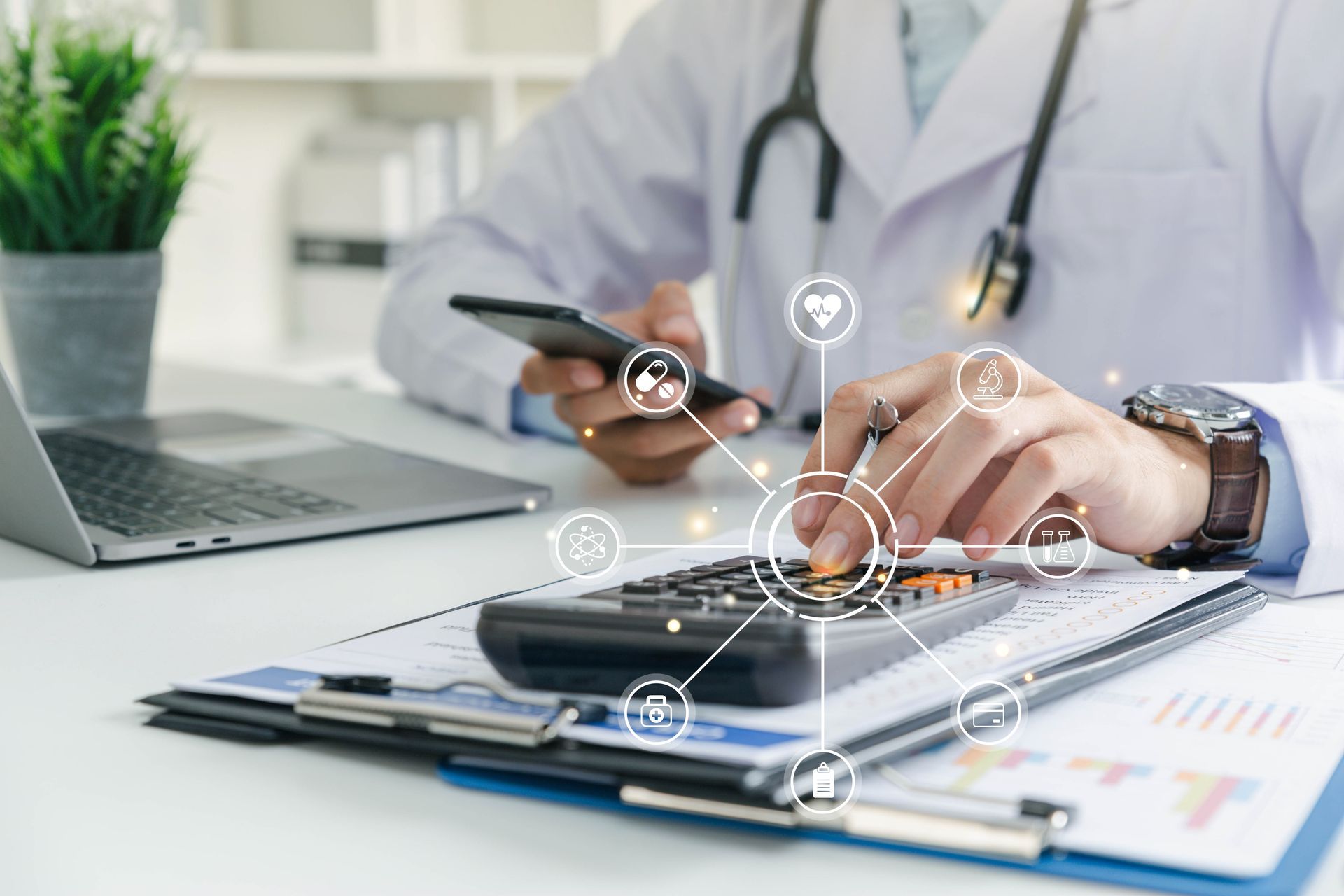 Doctor using a tablet and stylus at a desk with laptop, clipboard, and medical digital icons