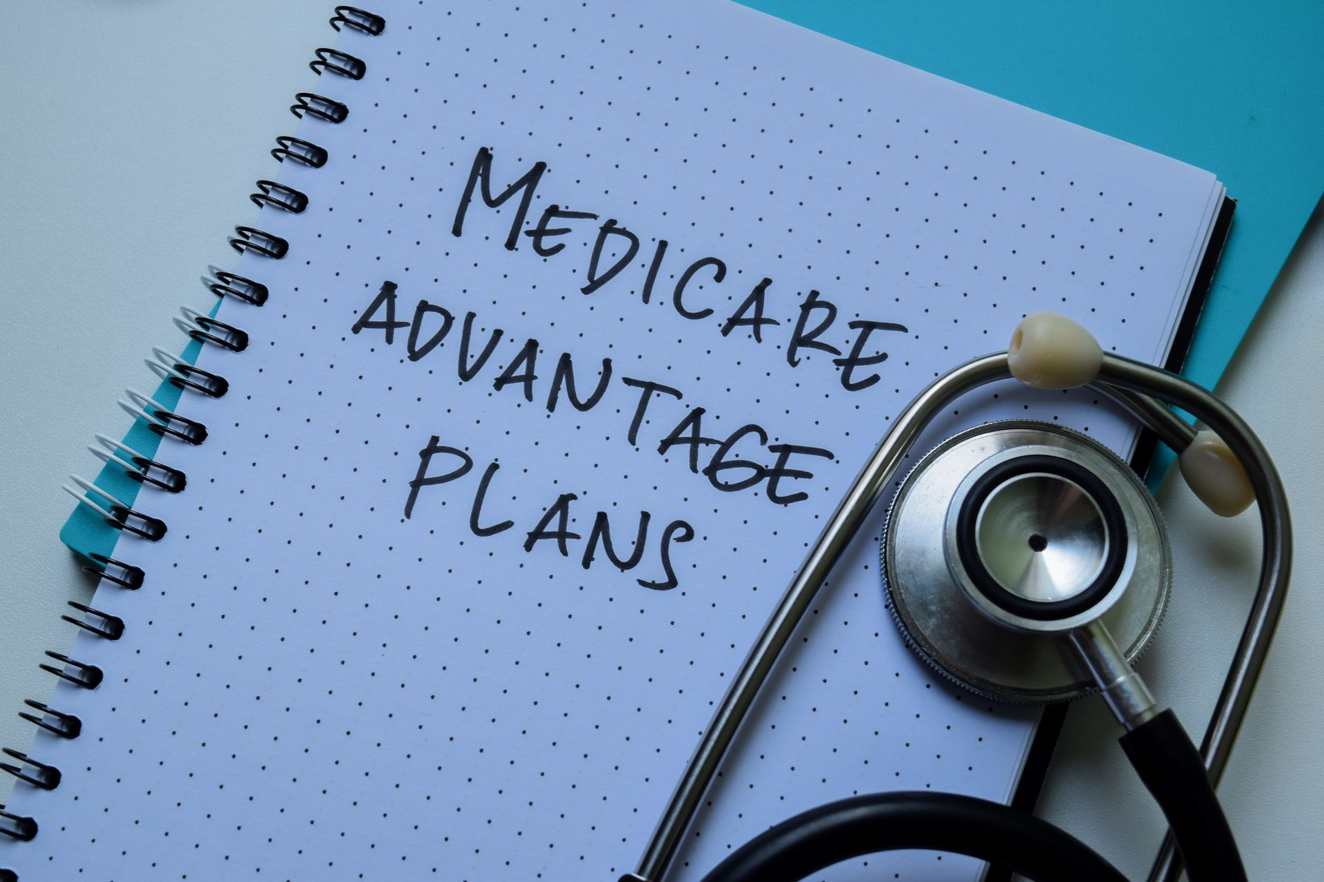 Notebook with “Medicare Advantage Plans” beside a stethoscope