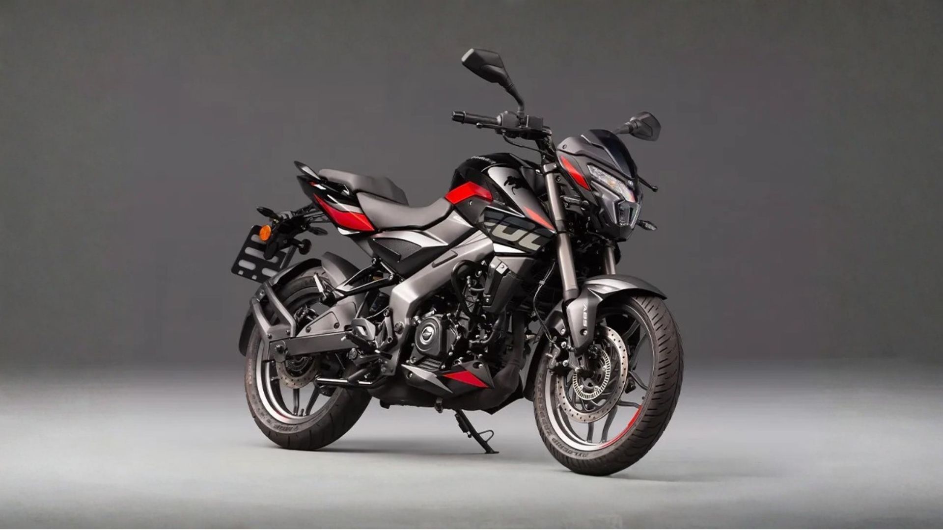 Black and red sport motorcycle on a gray studio background