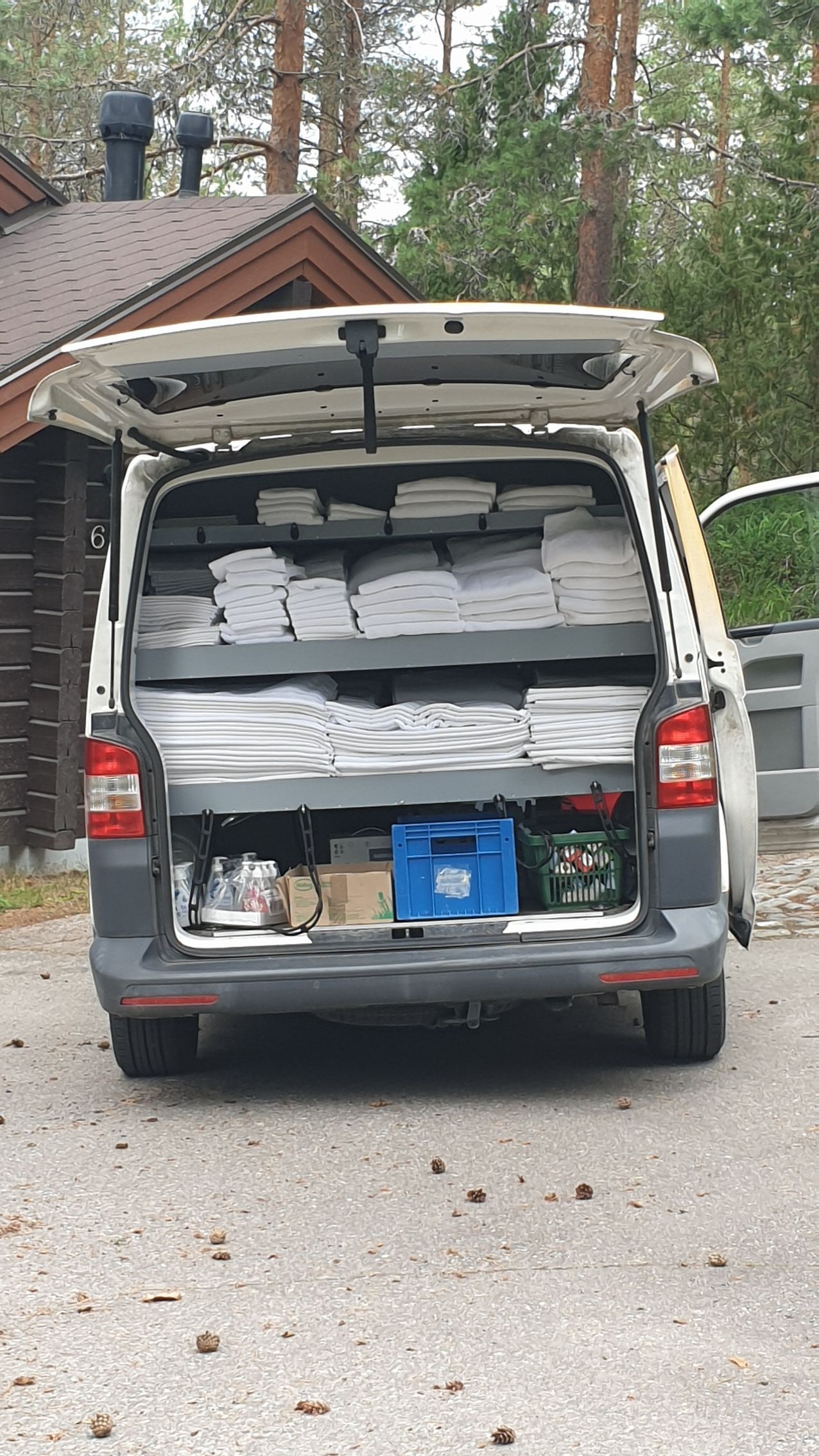 The back of a van is open and filled with lots of items.