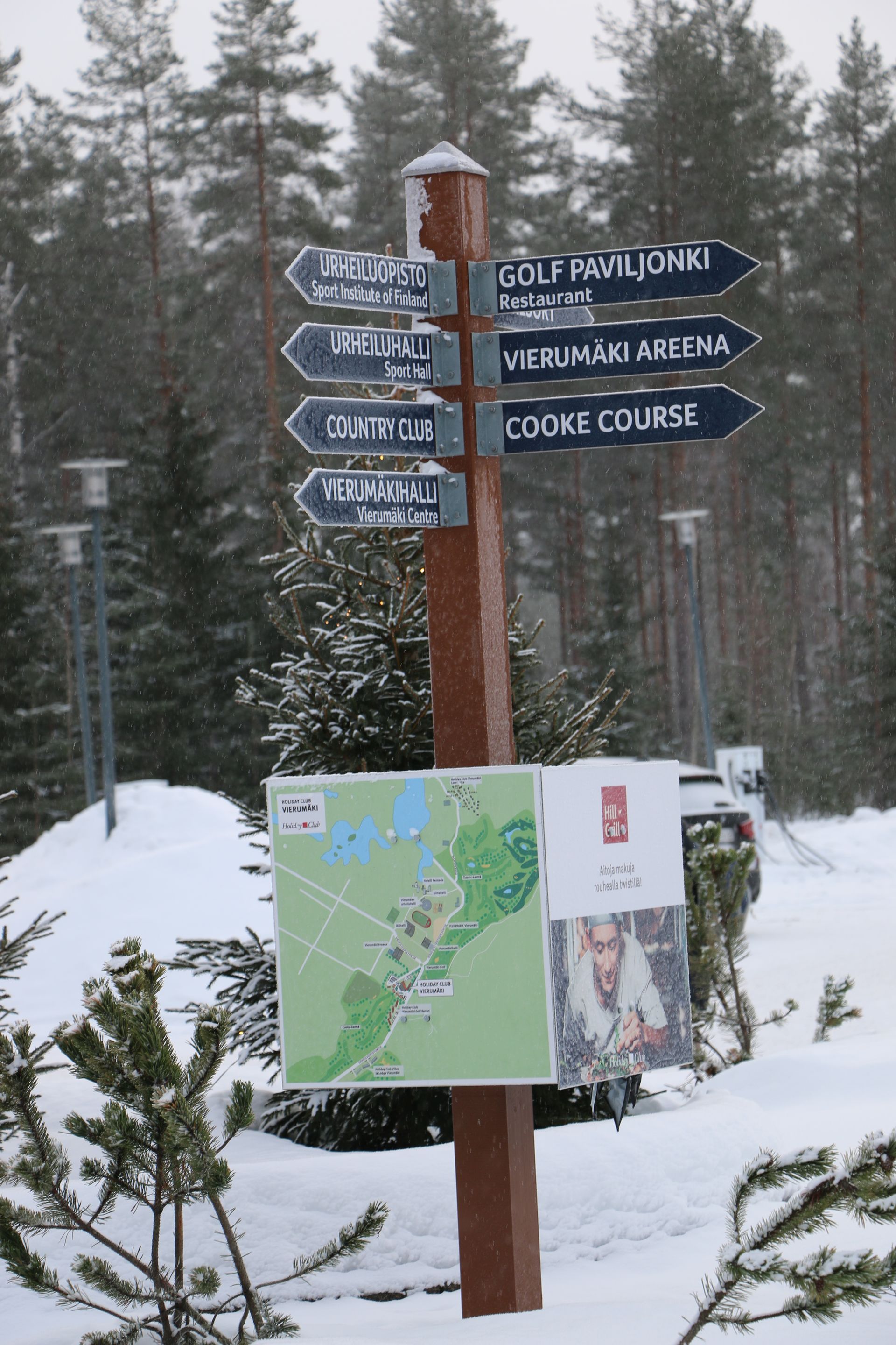 A wooden post with arrows pointing in different directions