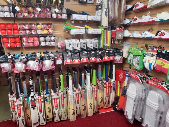 cricket bats, gloves and shoes`