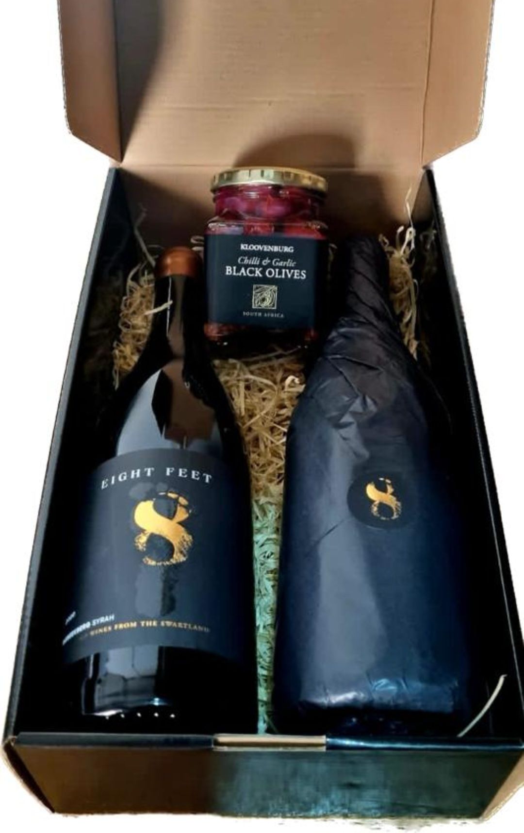 Two bottles of wine and a jar of jam are in a box supplied by BlinC Corporate.