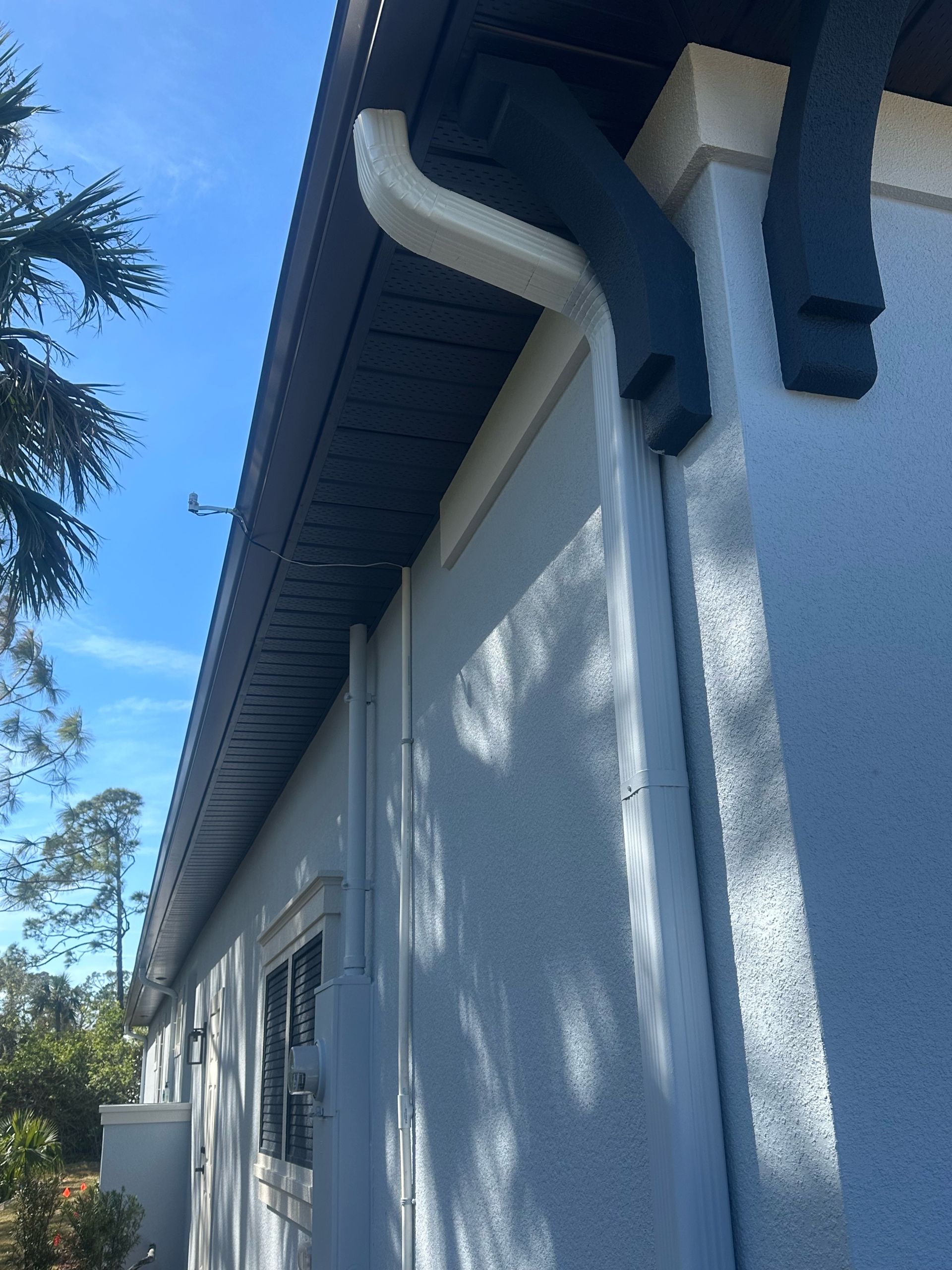 A house with a gutter on the side of it