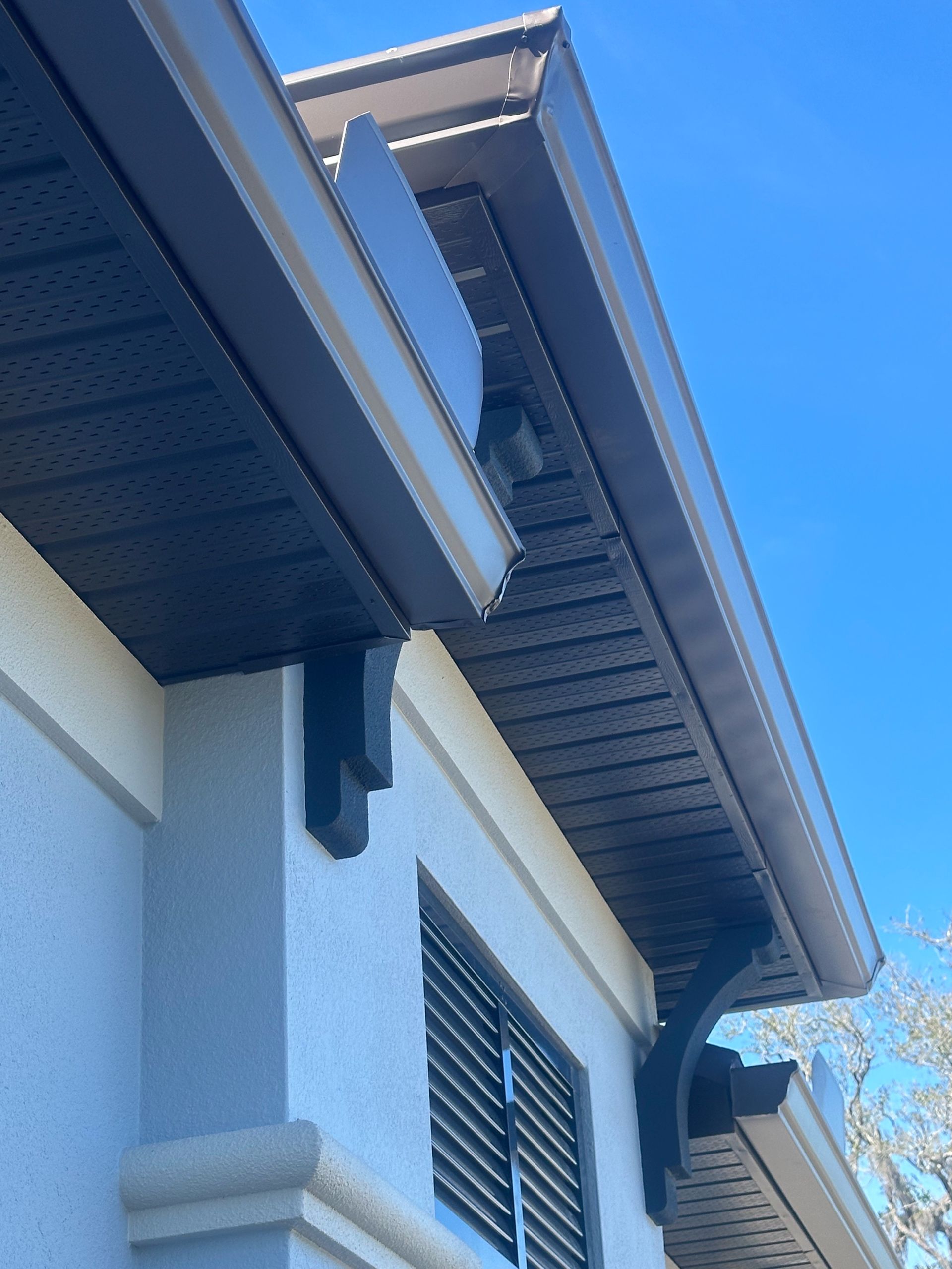 The roof of a building with a blue sky in the background