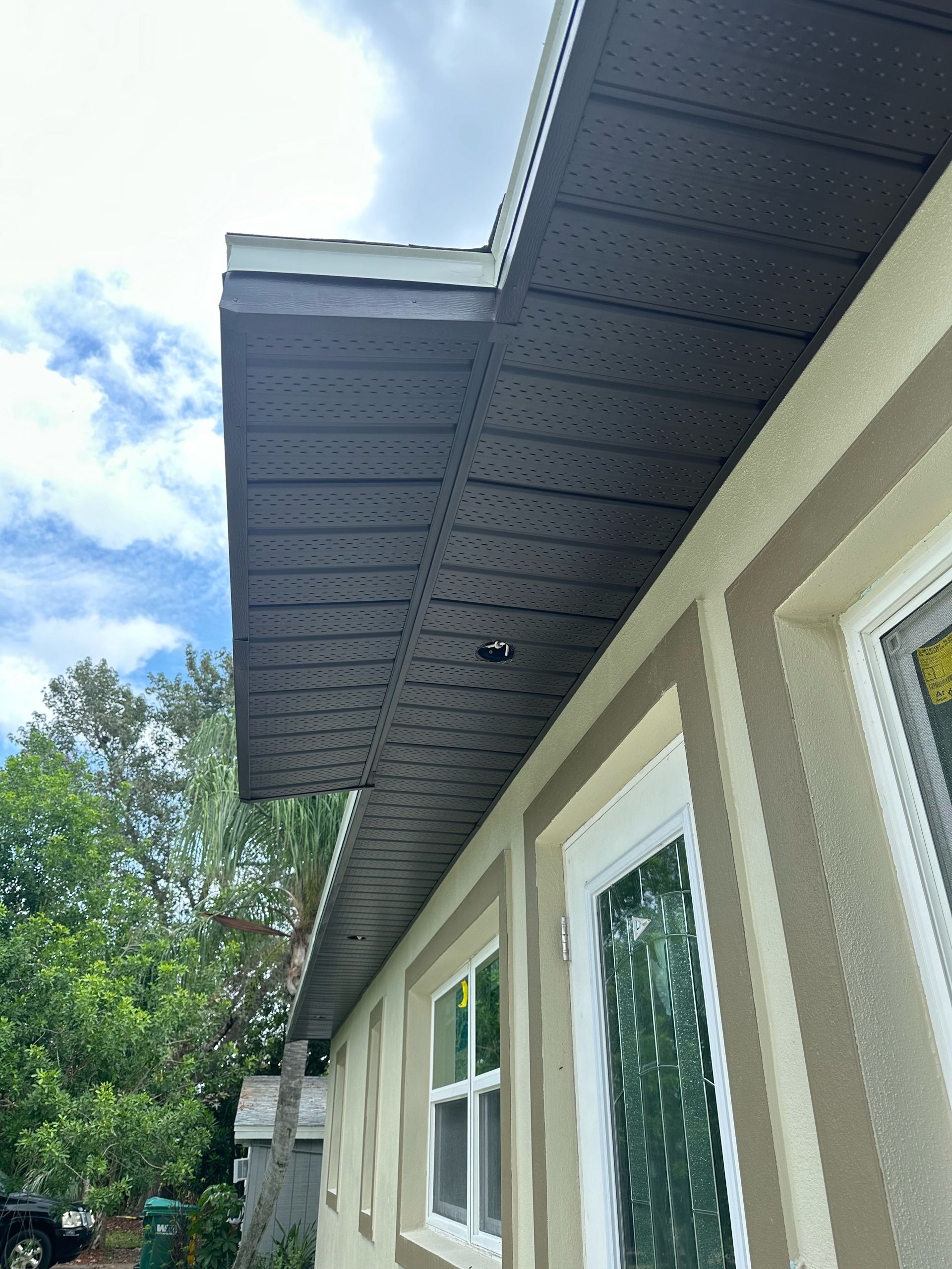 A house with a roof that has a gutter on it.