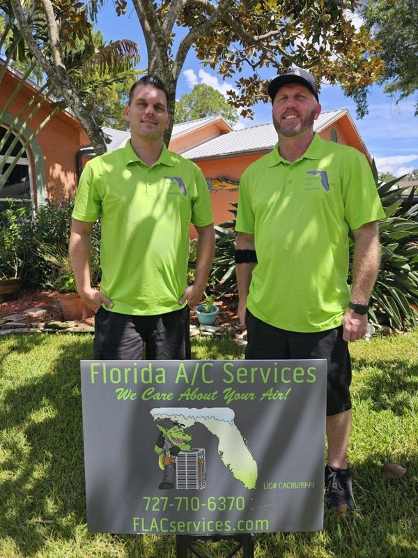 Tim and Stephen Troutt, co-founders of Florida AC Services, beside their branded company van in Largo, FL