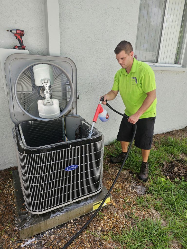 Technician servicing AC condenser unit