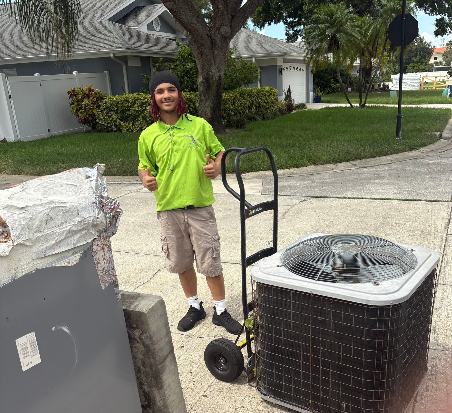 Technician mounting ductless mini-split in Florida living room