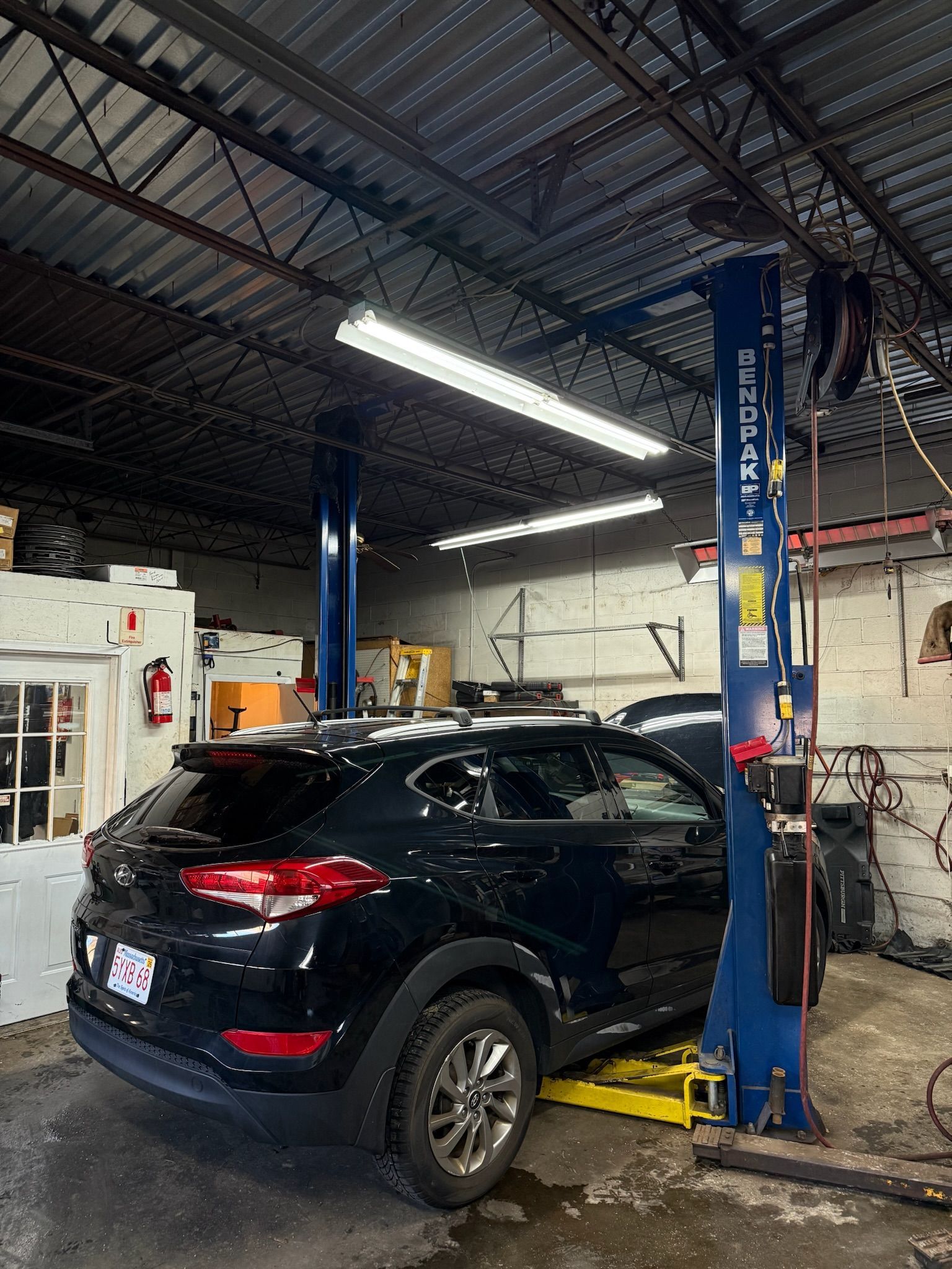 Black SUV On Lift Inside Auto Repair Facility | C&Z Auto Repairs