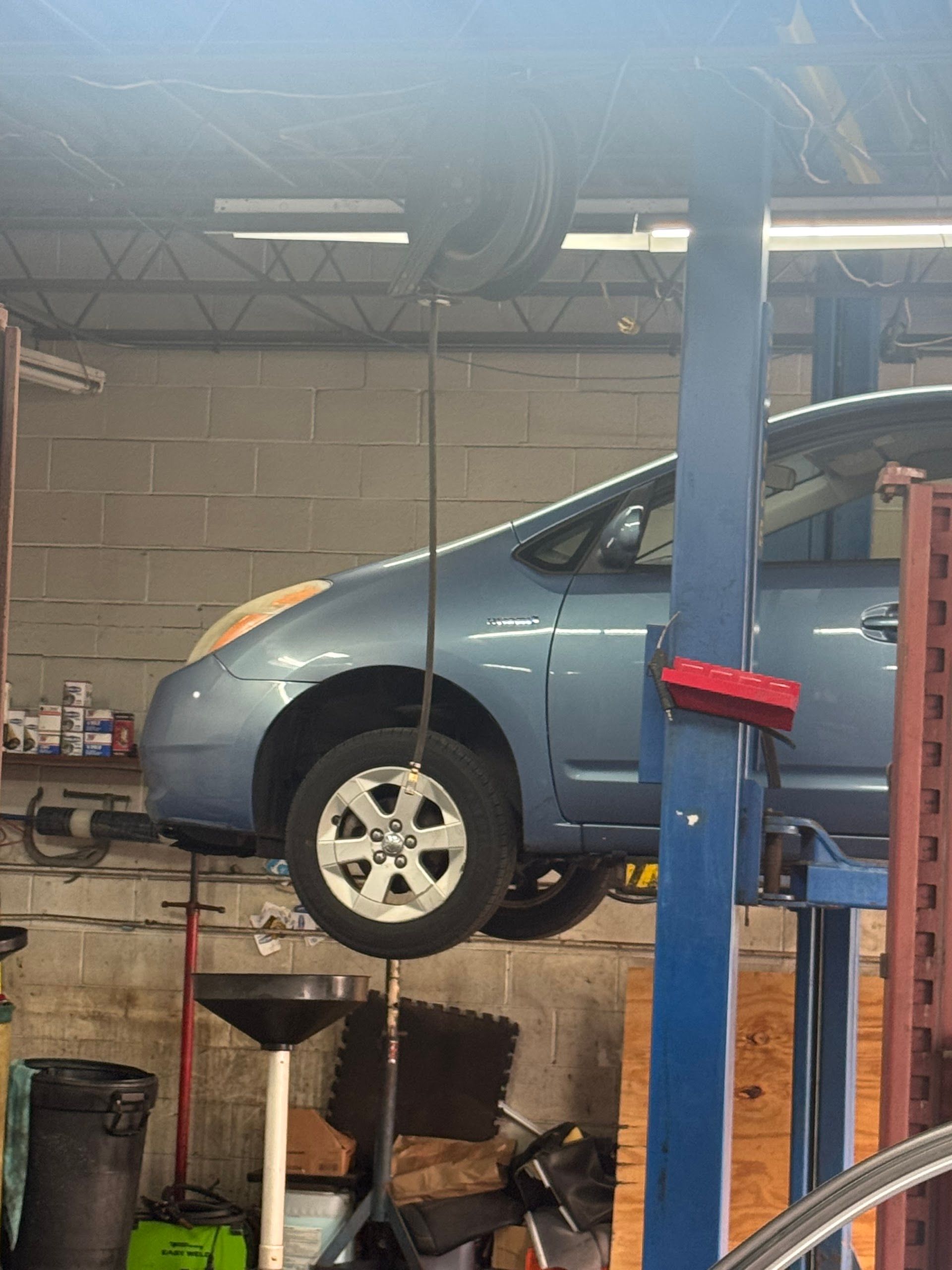 Silver Vehicle On Lift Inside Auto Repair Shop | C&Z Auto Repairs