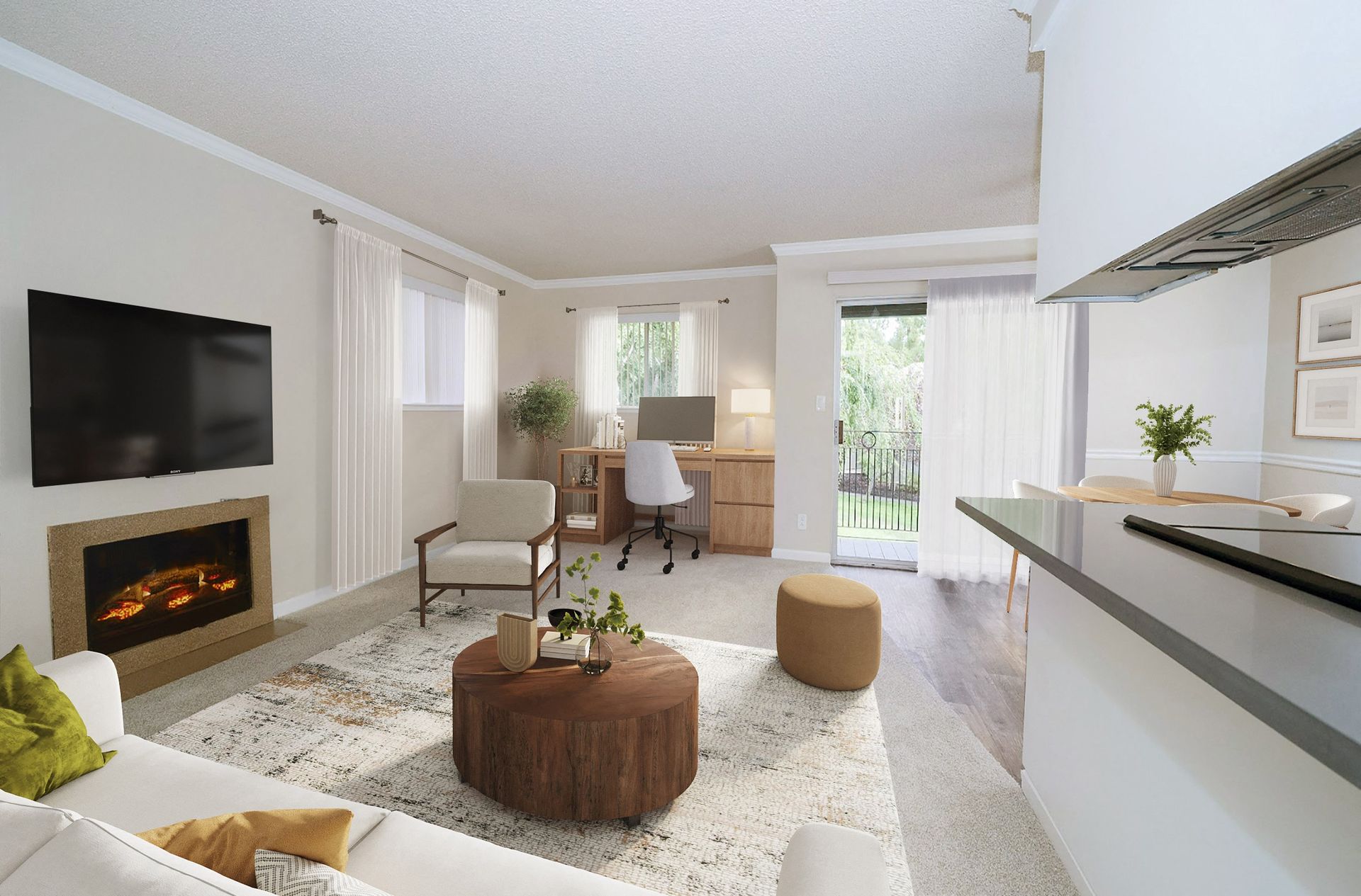 Bright apartment living room with fireplace, TV, desk, and sliding balcony doors at Valley Ridge Apartments.