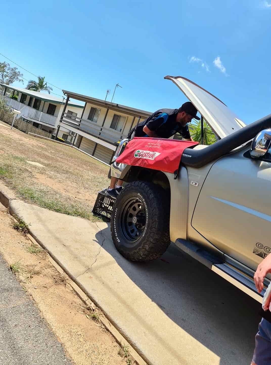 A Man Is Working On The Hood Of A Truck — M8S Rates Mechanical In Gladstone Central, QLD