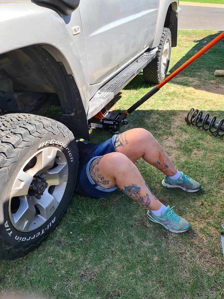 A Person Is Laying On The Ground Under A Truck — M8S Rates Mechanical In Gladstone Central, QLD
