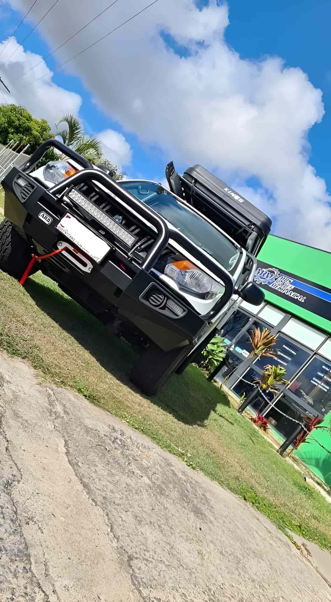 A Black Truck Is Parked On The Side Of The Road In Front Of A Building — M8S Rates Mechanical In Gladstone Central, QLD