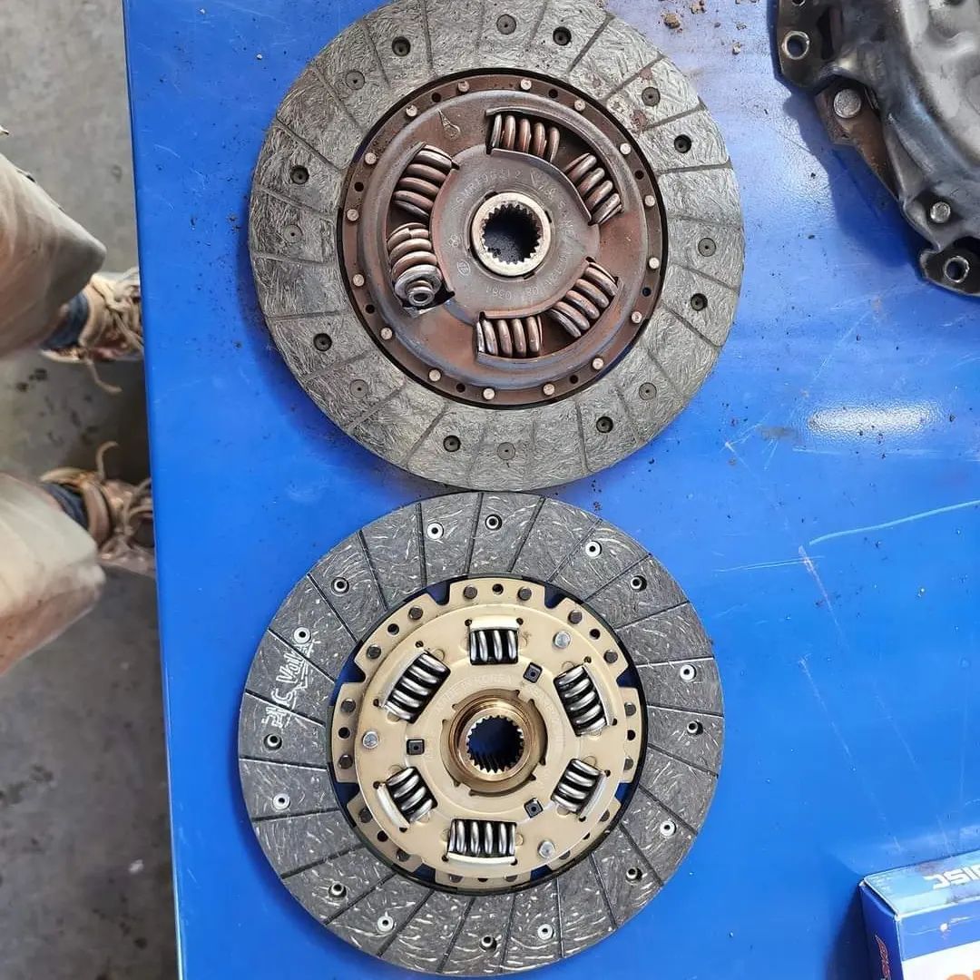 Two Clutch Discs Are Sitting On A Blue Table — M8S Rates Mechanical In Gladstone Central, QLD